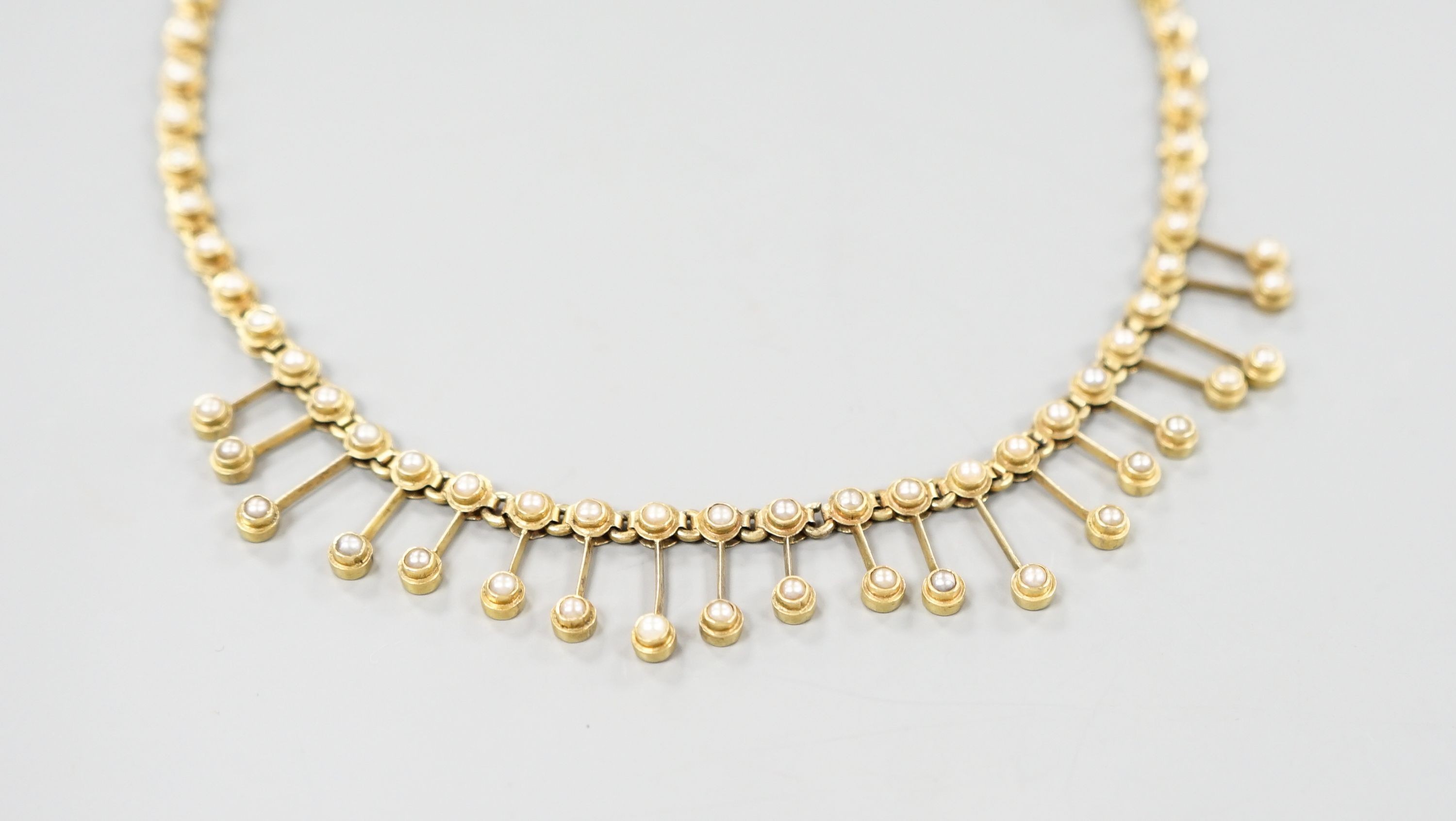A late Victorian yellow metal and seed pearl set fringe choker necklace, 33cm, gross 18.4 grams.